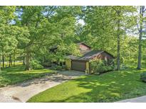 Beautiful wooded lot with a two story house and attached garage in a suburban neighborhood at 577 Century Oaks Dr, Zionsville, IN 46077