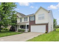 Charming two-story home featuring a two-car garage, well-maintained lawn, and inviting front porch at 6552 Hunters S Rdg, Zionsville, IN 46077