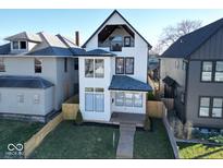 Stunning two-story home with a modern design, large windows, and a well-manicured front yard at 811 E Minnesota St, Indianapolis, IN 46203