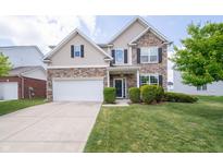 Charming two-story home with stone and siding, a two-car garage, and a well-manicured lawn at 8710 N Aspen Way, McCordsville, IN 46055