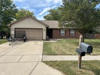 Charming single-story home with a well-maintained lawn and a two-car attached garage at 892 Millbrook Dr, Avon, IN 46123