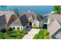 Beautiful waterfront home with manicured lawn and private boat dock access to the lake at 11065 Spice Ln, Fishers, IN 46037