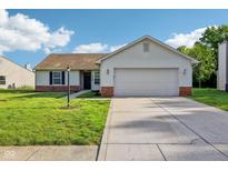 Charming single-story home featuring a well-manicured lawn and an attached two-car garage at 12250 Longstraw Dr, Indianapolis, IN 46236