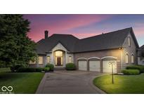 Stunning brick home boasts a three-car garage, mature landscaping, and a welcoming stone entrance at 14711 Macduff Dr, Noblesville, IN 46062
