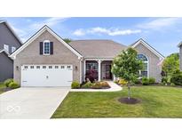 Charming brick home featuring a manicured lawn, two-car garage, and inviting front porch with beautiful landscaping at 1539 Hazy Falls Blvd, Westfield, IN 46074