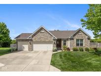 Charming brick ranch home with well-manicured lawn, three-car garage, and inviting front entrance at 16126 Hymera Green, Westfield, IN 46074