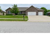 Beautiful brick home featuring a two-car garage and well-maintained landscaping at 2330 Oak Dr, Clayton, IN 46118