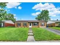 Charming brick home features a well-manicured front lawn and inviting walkway at 2538 Sickle Rd, Indianapolis, IN 46219