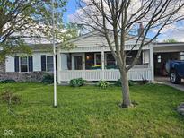 Charming single-story home with a stone accent, a lovely porch, and a well-maintained front yard at 315 Schoolhouse Rd, Franklin, IN 46131