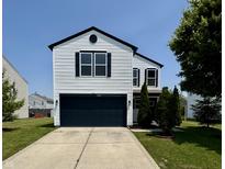 Charming two-story home features a dark garage door, white siding, and manicured lawn at 3327 Brandenburg Blvd, Indianapolis, IN 46239