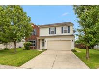 Charming two-story home with a brick facade and well-manicured lawn at 3623 Carroll Farms Dr, Indianapolis, IN 46235