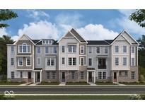 Charming new construction townhomes featuring varied facade designs, brick accents, and inviting front entrances at 410 Elite St # 2-602, Westfield, IN 46074