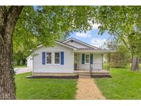Charming home featuring blue shutters, well-maintained lawn, and inviting front porch at 425 Patterson Rd, Columbus, IN 47203