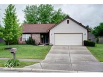 Charming single-story home with a well-manicured lawn and a two-car garage at 444 Austin Dr, Avon, IN 46123