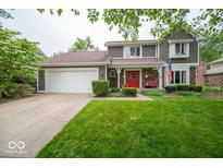 Charming two-story home with a red front door, landscaped yard, and an attached two-car garage at 506 Deerberry Dr, Noblesville, IN 46062