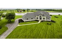 Stunning home boasts manicured lawn and stone accents near a serene lake at 5758 N 900 W, Thorntown, IN 46071