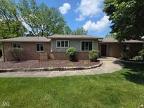 Charming single-story home with a well-manicured lawn and lush landscaping, providing great curb appeal at 652 Spring Hills Dr, Zionsville, IN 46077
