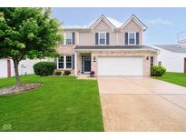 Charming two-story home with brick accents, a well-manicured lawn, and a two-car garage at 73 Spring Lake Dr, Westfield, IN 46074