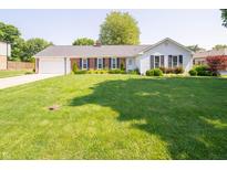 Charming one-story home featuring a well-manicured lawn and brick accents at 7450 Cotherstone Ct, Indianapolis, IN 46256