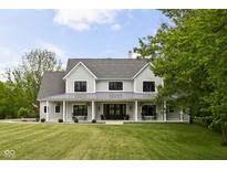 Charming two-story home with a metal roof, covered front porch, black trimmed windows, and a well-manicured lawn at 8555 S County Road 375 E, Mooresville, IN 46158
