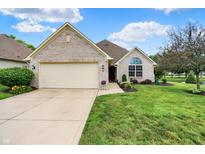 Charming, single-story brick home with a well-manicured lawn and an attached two-car garage at 896 Fairfield Dr, Greenfield, IN 46140