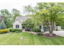 Charming stone and siding home with a well-manicured lawn, lush landscaping, and a welcoming front porch at 11020 Florida Rd, Fortville, IN 46040