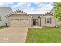 Charming single-Gathering home featuring a 2-car garage and well-maintained lawn at 123 Campus Ln, Greenwood, IN 46143