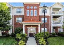 Beautiful condo building showcasing brick facade, covered entryway, and well-maintained landscaping at 17233 Gunther Blvd # 102B, Westfield, IN 46074
