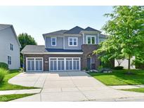 Attractive two-story home with a three car garage, beautiful lawn and brick and siding facade at 18726 Tillamook E Run, Noblesville, IN 46062
