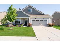 Charming single-Gathering home with manicured lawn, inviting front porch, and a two-car attached garage at 19581 Sumrall Pl, Westfield, IN 46074