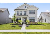 Charming two-story home with black trimmed windows and a well-manicured lawn at 2223 Ryder Pl, Westfield, IN 46074