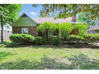 Charming brick bungalow featuring lush landscaping and inviting curb appeal at 2905 N Warman Ave, Indianapolis, IN 46222