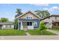 Charming two-story home with a welcoming porch and well-manicured lawn, creating a cozy curb appeal at 3227 Guilford Ave, Indianapolis, IN 46205