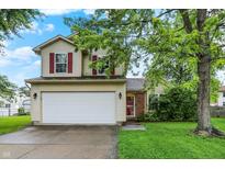 Charming two-story home with red shutters, attached two car garage, and a well maintained lawn at 5369 Red River Ct, Indianapolis, IN 46221