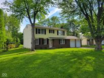 Charming two-story home featuring an attached two-car garage and a well-maintained lawn at 5515 Lunsford Dr, Indianapolis, IN 46237