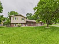 Charming two-story home featuring a well-manicured lawn and inviting exterior, perfect for Gathering living at 5542 N Olivia Dr, Alexandria, IN 46001