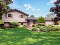 Charming two-story home with landscaped front yard and brick accents, creating a welcoming curb appeal at 5730 Teresa Dr, Alexandria, IN 46001