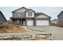 Charming two-story home with a two-car garage and a modern gray brick and siding facade at 6049 Madera Dr, Whitestown, IN 46075