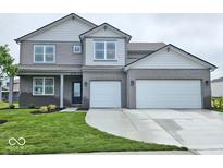 Charming two-story home with a two-car garage, landscaped yard, and a welcoming covered front porch at 6049 Madera Dr, Whitestown, IN 46075