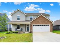Charming two-story home featuring a brick facade and inviting front porch at 6645 Honeysuckle Way, Pendleton, IN 46064