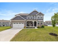 Charming two-story home with a well-manicured lawn and a two-car garage at 6923 Bryant Pl, Plainfield, IN 46168