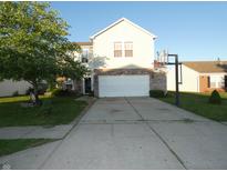 Two-story home featuring a brick and vinyl facade, attached garage, and a basketball hoop in the driveway at 8609 Wheatfield Dr, Camby, IN 46113