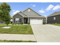 Charming single-story home with brick and siding, a two-car garage, and a well-manicured lawn at 998 Cherry Tree Ln, Greenwood, IN 46143