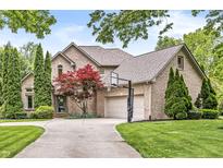 Lovely two-story brick home featuring an attached three car garage, basketball hoop and beautiful landscaping at 10697 Woodmont Ln, Fishers, IN 46037