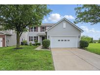 Charming two-story home with a well-manicured lawn and a two-car garage at 10722 Landsbrook N Run, Noblesville, IN 46060