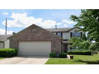 Charming two-story home featuring a brick facade, attached two-car garage, and manicured front yard at 1129 Central Park S Blvd, Greenwood, IN 46143
