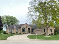 Beautiful brick home with a well-manicured lawn and curved driveway at 12231 Valley View Cir, Indianapolis, IN 46229