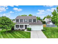 Charming two-story home featuring a well-manicured lawn and a classic white exterior with black shutters at 1234 Breaside Cir, Greenwood, IN 46143