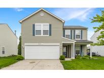 Two-story home featuring neutral siding, blue shutters, a well-kept lawn, and a two-car garage at 12444 Bearsdale Dr, Indianapolis, IN 46235