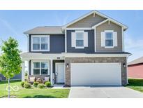 Beautiful two-story home featuring stone accents, a two-car garage, and manicured landscaping at 1529 Fairmount Dr, Greenfield, IN 46140